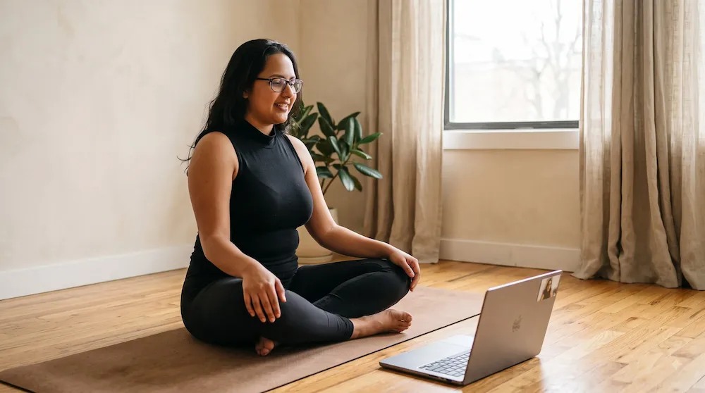 Simran teaching an online yoga session from her practice space